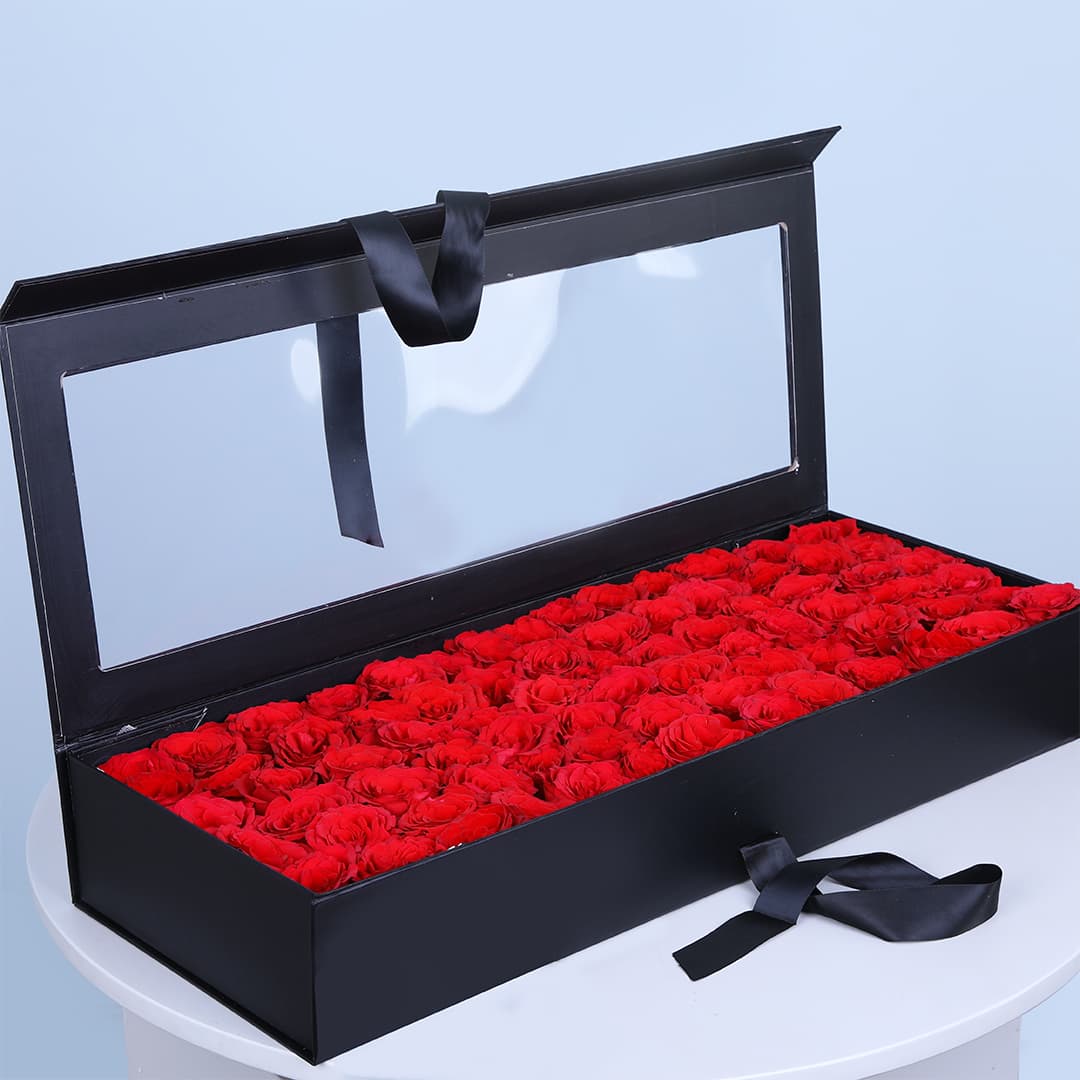 Luxury black box with premium red roses with a transparent lid.