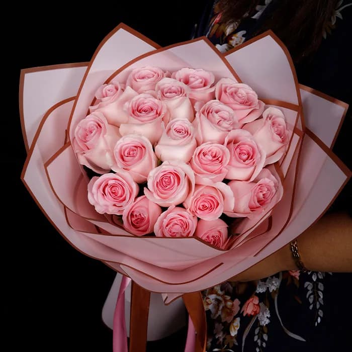 Bouquet featuring 20 pink roses with matching coloured pink wrap tied with a ribbon.