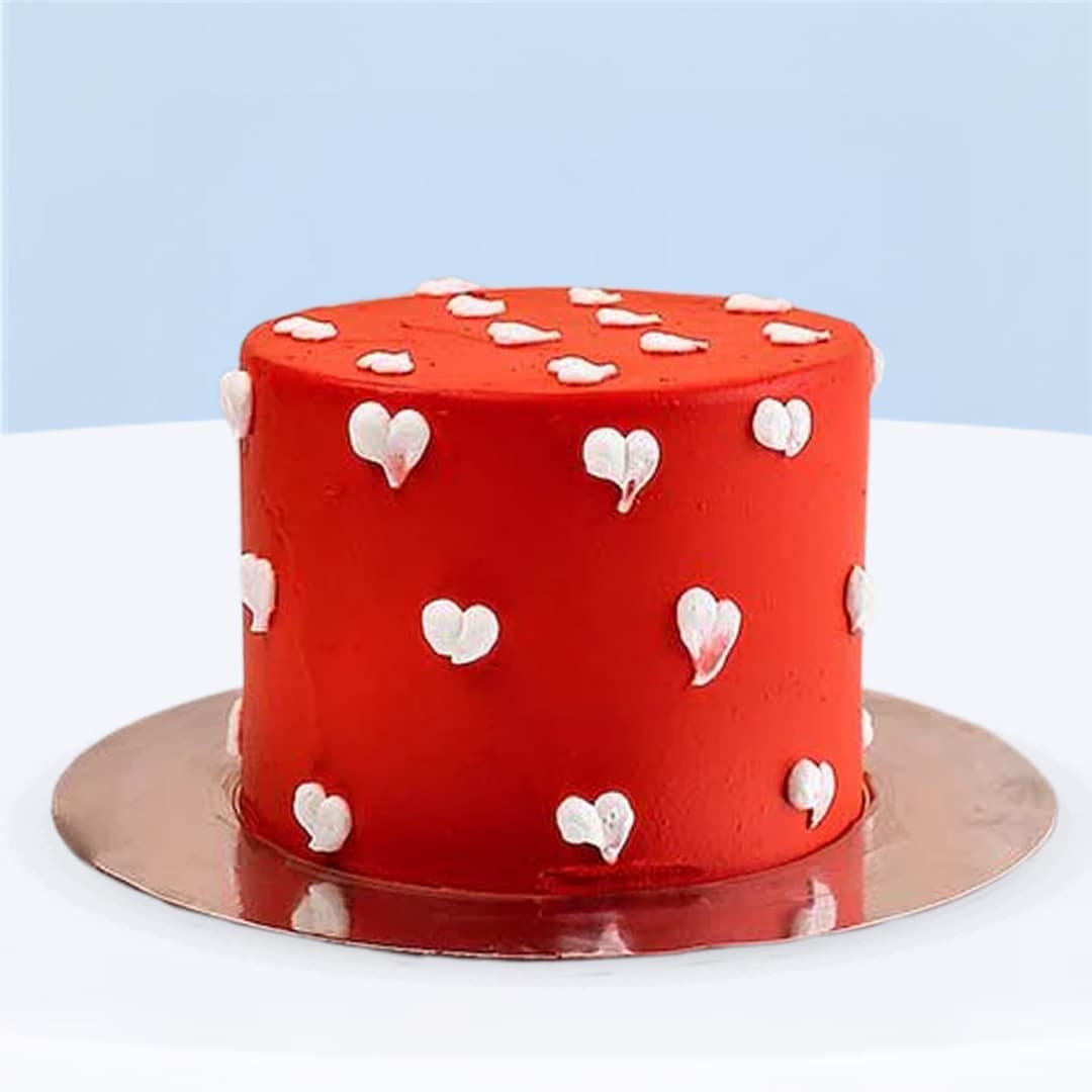 Red buttercream cake with white heart decorations, 500 grams.