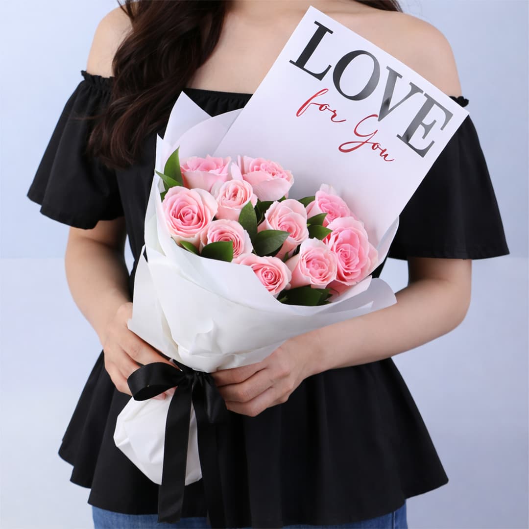 Pink roses and greenery in elegant white wrapping, finished with a "LOVE For You" message card.