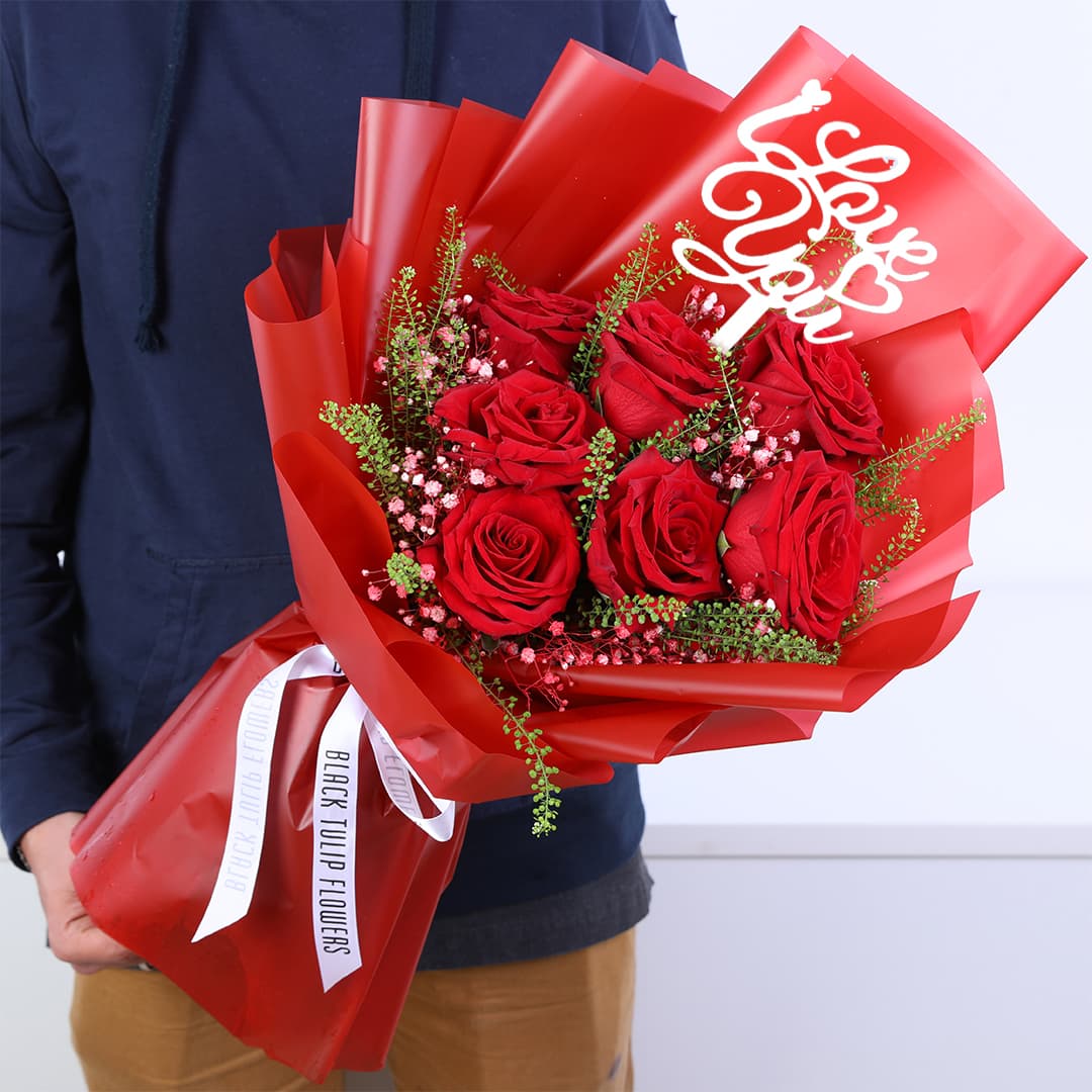 Valentine mini bouquet with fresh red roses and fillers, hand-tied in an elegant wrapping for romantic gifting.