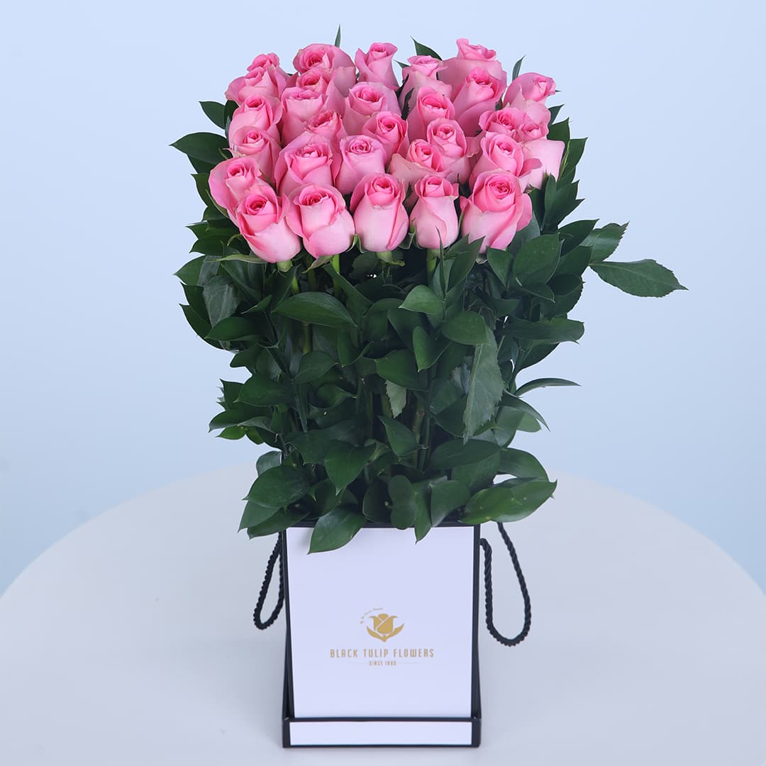 15 Blush pink roses in a white floral bag