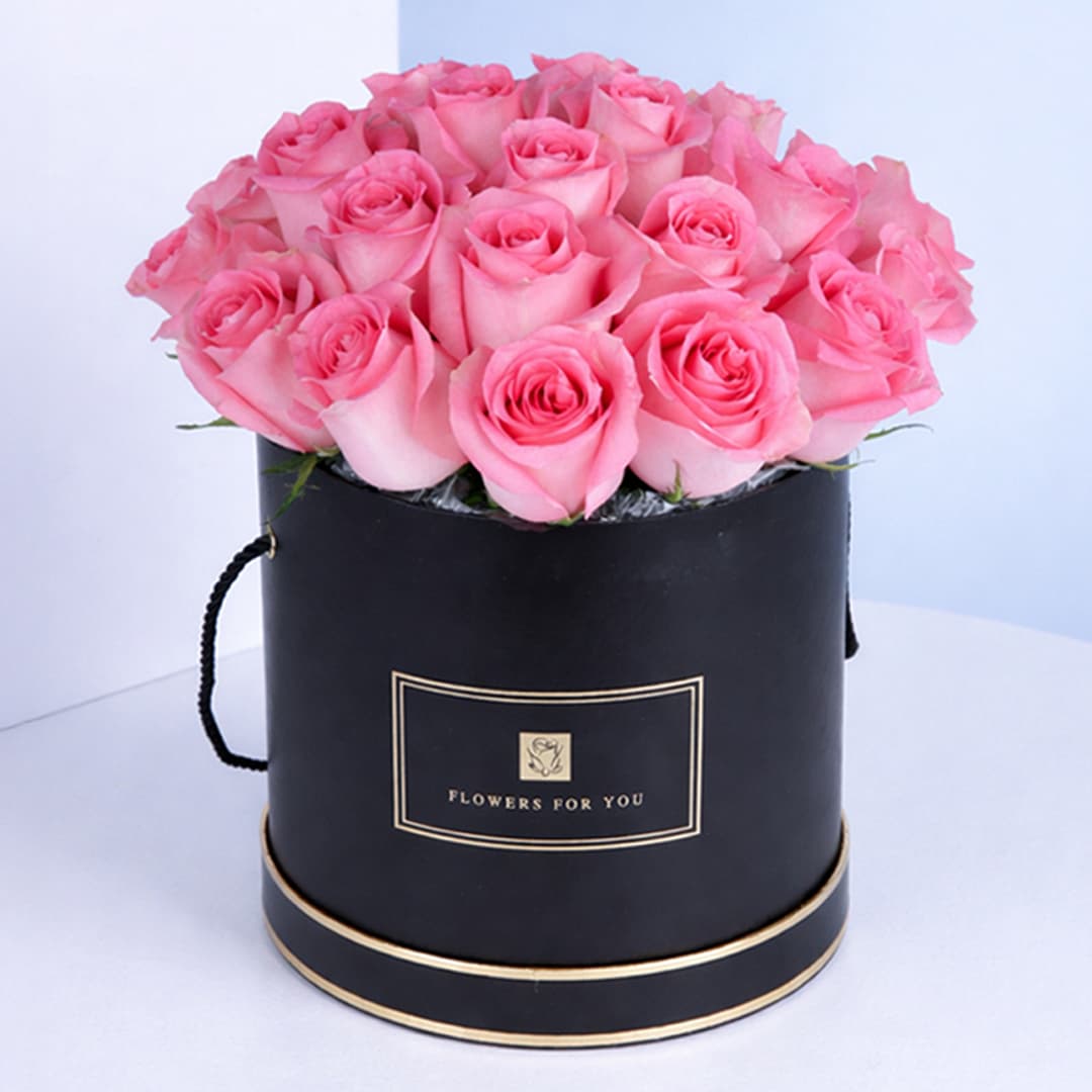 Elegant pink rose box showcasing a beautiful arrangement of fresh roses, perfect for gifting or home decor.