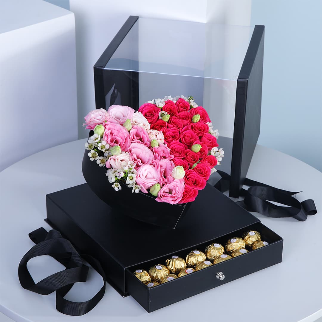 Lisianthus and Baby Roses in a heart-shaped arrangement in a box with a draw filled with Ferrero Rocher chocolates.