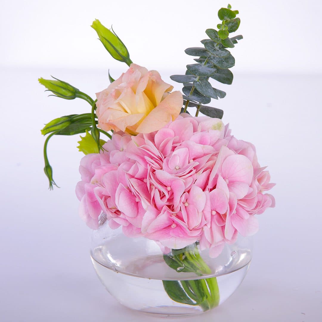 Pink centerpiece flower arrangement consists of Hydrangeas, Lisianthus and Eucalyptus