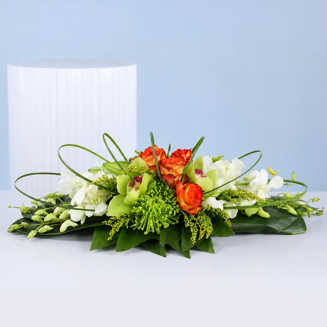 Premium centrepiece with orchids, roses, and chrysanthemums for elegant table styling at weddings, receptions, and interiors