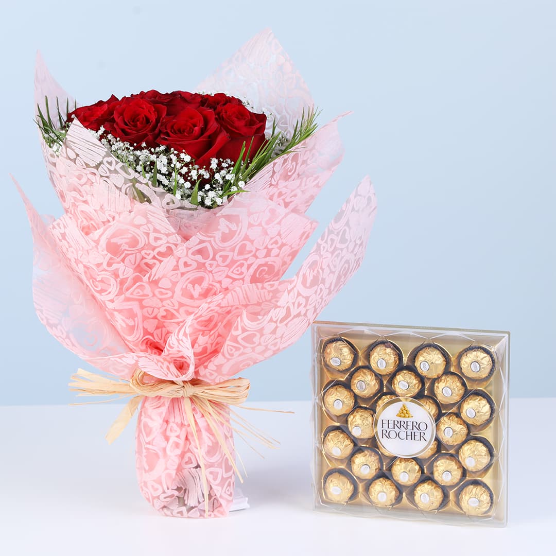 Red rose bouquet with white fillers and green foliage wrapped in pink paired with Ferrero Rocher chocolate box.